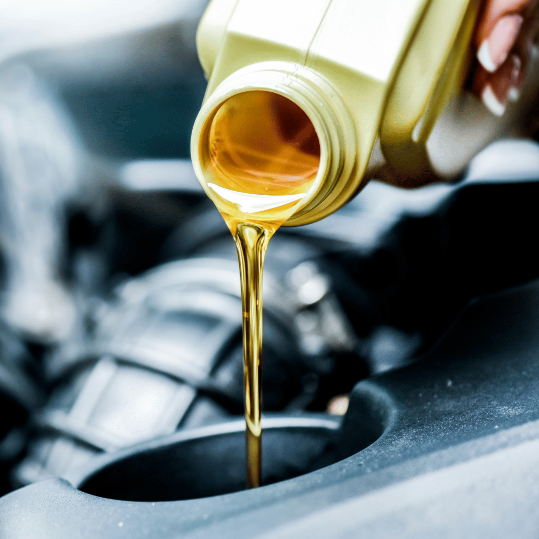 Expert oil change service: An image capturing the precise moment of pouring fresh oil into an engine, symbolizing our professional and efficient oil change services for optimal engine performance and maintenance.